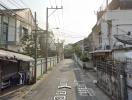 Urban residential street with eletrical wires and surrounding houses