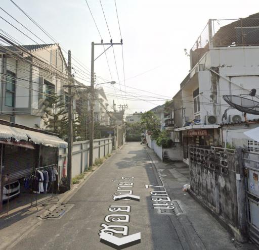 Urban residential street with eletrical wires and surrounding houses