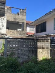 View of a building needing renovation with neighboring houses