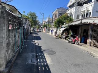 Urban street with buildings and parked motorcycles under clear sky