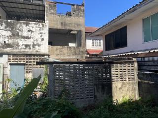 View of a residential property exterior showing buildings and a gated area