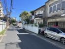 Residential street view with houses and parked cars