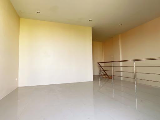 Spacious and brightly lit empty living area with large windows and balcony