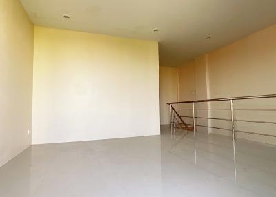 Spacious and brightly lit empty living area with large windows and balcony