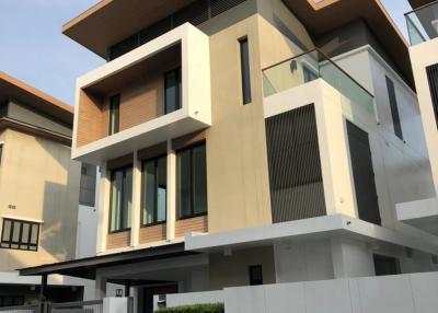 Modern two-story residential home with large windows and a flat roof