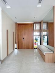Modern entryway with wooden paneling and sleek furniture