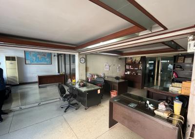 Spacious office area with multiple workstations and natural lighting