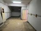 Empty commercial space with white walls and tiled floor