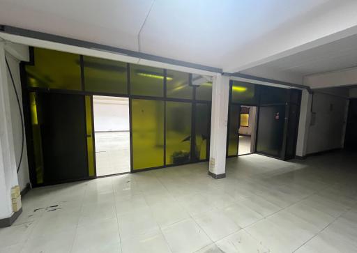 Interior view of a commercial building space with frosted glass partitions