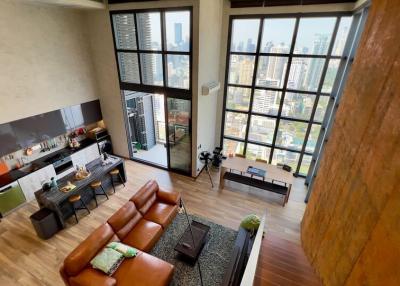 Spacious living room with high ceiling and city view