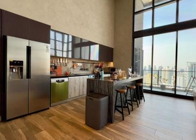 Modern kitchen with stainless steel appliances and city view