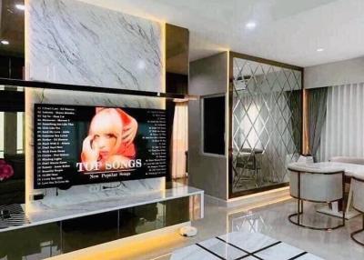 Modern Living Room with Marble Wall and Large TV Screen