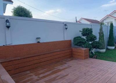 Spacious wooden deck with built-in bench and privacy wall