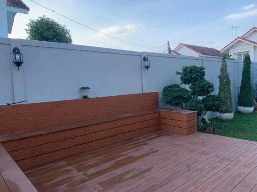 Spacious wooden deck with built-in bench and privacy wall