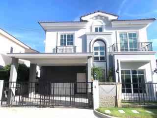 Modern two-story house with balconies and a covered garage