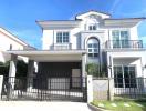 Modern two-story house with balconies and a covered garage