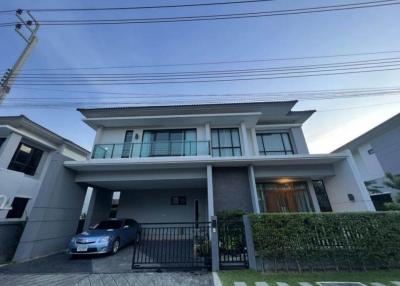 Modern two-story house with a car parked in the driveway