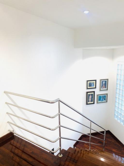 Modern staircase with wooden steps and metal railings