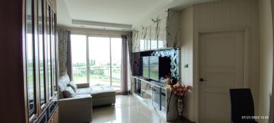 Spacious and well-lit living room with modern decor and balcony access