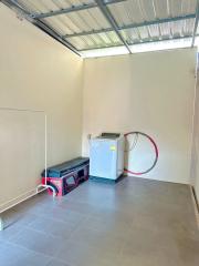 Spacious utility room with washing machine and storage shelves