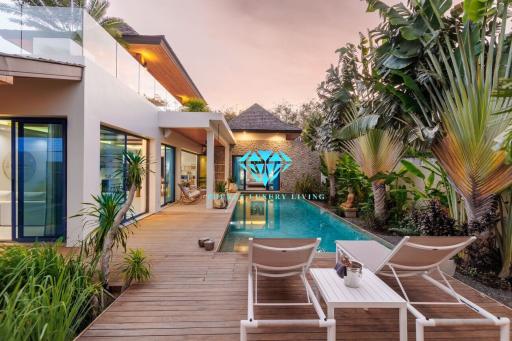 Luxury home exterior with swimming pool and lounging area at dusk