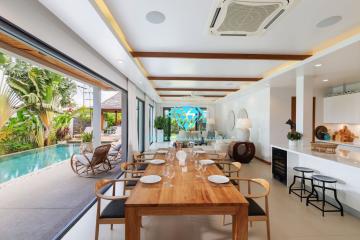 Spacious open concept living area with dining set, kitchen and view of the pool