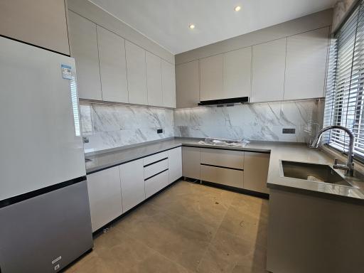 Modern kitchen with marble countertops and built-in appliances