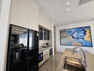 Modern kitchen with stainless steel appliances and artistic wall decor