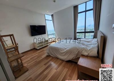 Bright bedroom with large window and city view