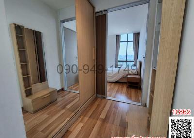 Spacious bedroom with hardwood floors and modern sliding door wardrobe