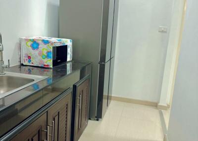 Modern kitchen with refrigerator and storage cabinets