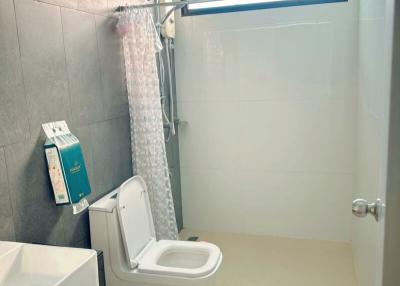Modern bathroom interior with shower, toilet, and sink