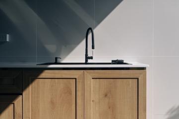 Modern kitchen with wooden cabinets and stainless steel sink