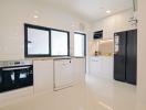 Modern kitchen with white cabinetry and stainless steel appliances