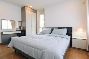 Modern bedroom with king-sized bed and ample natural light