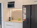 Modern kitchen with stainless steel appliances and white cabinetry