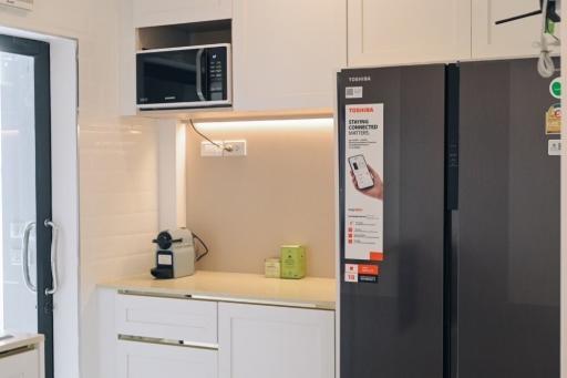 Modern kitchen with stainless steel appliances and white cabinetry