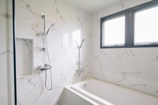 Modern bathroom with marble tiles and bathtub