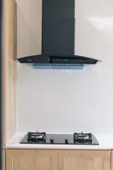 Modern kitchen with stainless steel range hood and gas stove