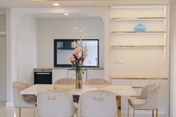 Modern living room with marble dining table and mounted television