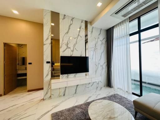 Elegant living room with marble walls and modern decor