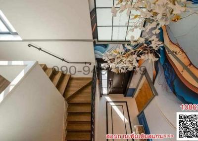 Modern staircase with artistic wall designs and high ceiling