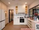 Modern kitchen with white cabinetry and stainless steel appliances