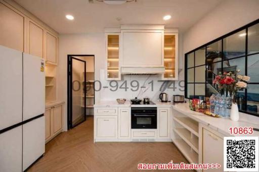 Modern kitchen with white cabinetry and stainless steel appliances