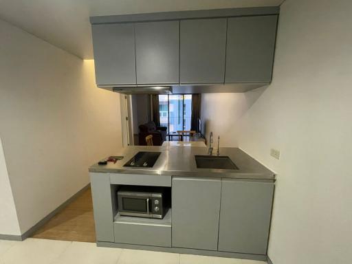 Modern kitchen with integrated appliances and a view into the living area