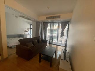 Contemporary living room with sofa and access to the balcony