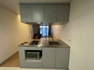 Modern kitchen with stainless steel appliances and a view into the living area