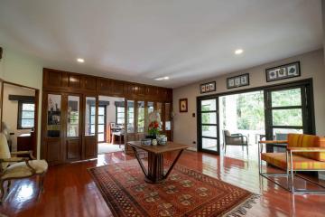 Spacious living room with hardwood floors and natural lighting