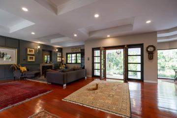 Spacious and elegant living room with natural light and hardwood floors