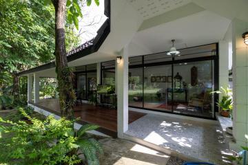 Spacious patio with sliding glass doors leading to a green lawn
